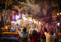 crowd watching a parade float at night at Universal Orlando's Mardi Gras.