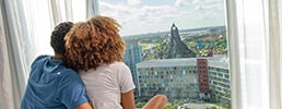 couple looking out window at resort