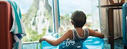 boy sitting in a pool tube looking out the window